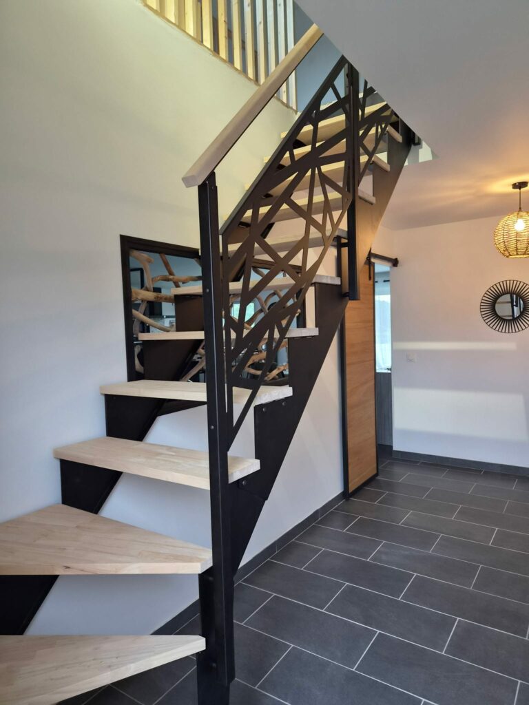 Escalier quart tournant en métal noir avec marches en bois et garde-corps sur mesure dans un intérieur contemporain.